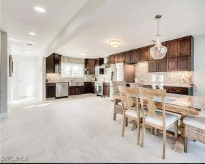 a kitchen with a table and chairs in a room at Luxury Home with Deeded Private Beach Access Sanibel Island - 28 Day Stay Minumum in Sanibel