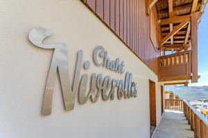 a sign on the side of a building at Cozy Alpine Chalet with Ski-In access and Parking in Val Thorens 10 Niverolles in Val Thorens +8 photos