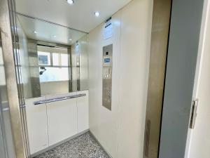 a elevator in a room with a glass door at Luxury Prestigia Fes - 7 Appartements - Vue Parc ou Quartier in Fès +149 photos