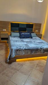 a bedroom with a large bed with a blue comforter at Marina Smir Compounds Pool & Beach in Marina Smir