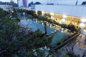 a swimming pool in the middle of a building with lights at Hotel Santika Bogor in Bogor
