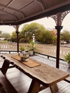 a wooden table sitting under a pavilion on a patio at Bank Hotel Dungog in Dungog