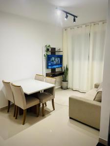 a living room with a table and a couch at Apartamento Ponta de Campina, 500m da Praia, com Vista Incrível do Pôr do Sol in Cabedelo +51 photos