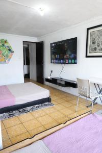 a bedroom with a bed and a tv on the wall at Hostal Centeno in Guadalajara