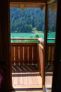 a view from the balcony of a house with a view of a lake at Mansarda vista lago in Auronzo di Cadore