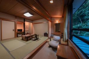 a train room with a table and a chair at ShirabuOnsen Higashiya in Yonezawa