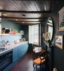a kitchen with blue cabinets and a table with chairs at One Church Square in Rye +17 photos