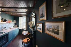 a kitchen with a blue wall with pictures on it at One Church Square in Rye