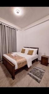 a bedroom with a large bed in a room at Rose Gold Kandy in Kandy