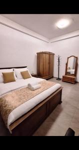 a large bed in a room with a mirror at Rose Gold Kandy in Kandy