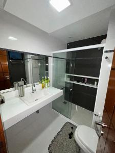 a bathroom with a shower and a sink and a toilet at Apartamento de Luxo in Belém +15 photos