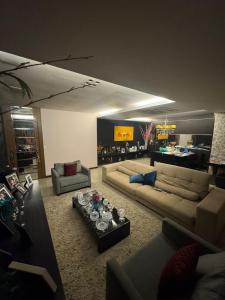 a living room with two couches and a tv at Apartamento de Luxo in Belém