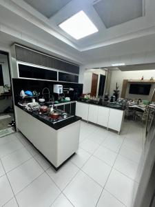 a large kitchen with a counter in a room at Apartamento de Luxo in Belém