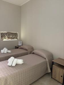 a bedroom with two beds with white pillows on them at Borgo Albergo Museum XIV in Melfi