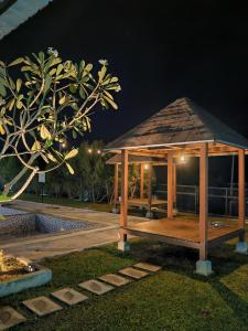 a wooden gazebo in a park at night at Laman Gadang in Johol