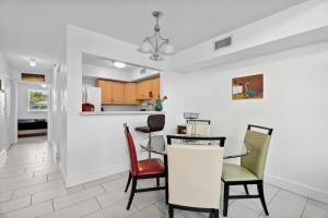a kitchen and dining room with a table and chairs at Saint Augustine Island Home with Hot Tub and Game Table in Saint Augustine
