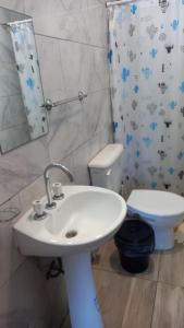 a bathroom with a sink and a toilet and a mirror at El Amanecer in Charata