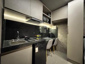 a kitchen with a sink and a counter top at Flat Luar Recanto Florah in Garanhuns