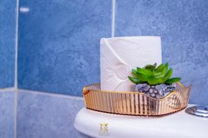 a basket on top of a toilet in a bathroom at The Monarch Suites in Lanet +41 photos