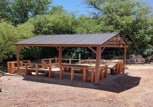 a wooden gazebo with a metal roof at VIGILANTE INN Invincible Quarters in Tombstone