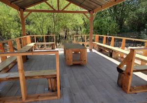 a wooden deck with benches and a table at VIGILANTE INN Invincible Quarters in Tombstone +8 photos