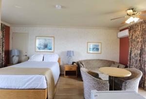 a hotel room with a bed and a couch at Motel Grand-Pré Inc in Bonaventure +34 photos