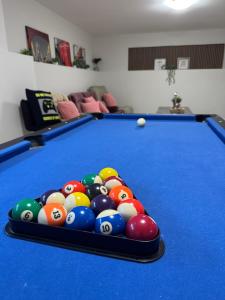 a pool table with a bunch of balls on it at Crystal's Place in Moncton