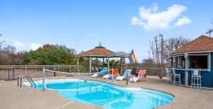 a swimming pool with chairs and a gazebo at Scenic 5-Acre Retreat with Hot Tub Pool & Game Room in Manor