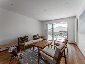 a living room with a couch and a table at Biscarrosse: Maison 5 chambres avec piscine privée - FR-1-521-258 in Biscarrosse