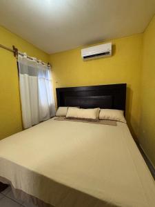 En eller flere senge i et værelse på Mi hogar feliz