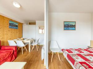a room with a bed and a table and chairs at Appartement 6 pers aux pieds des pistes à Saint-François-Longchamp - FR-1-807-29 in Saint-François-Longchamp