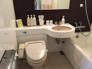 a bathroom with a toilet and a sink at Hotel Siena in Tokyo