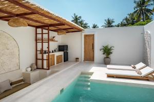 a villa with a swimming pool and a kitchen at Kasih 2 - Villa with private pool in Gili T in Mantaak