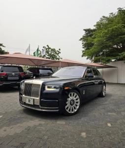 a black limousine parked in a parking lot at A4 Express in Maiyegun