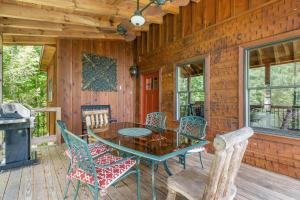 a dining room with a table and chairs on a deck at Mountain Blessings 