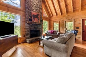 a living room with a fireplace and a tv at Mountain Blessings 
