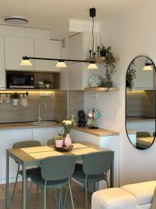 a kitchen and dining room with a table and chairs at Dorin Kutak, Green Hills Divčibare in Divčibare