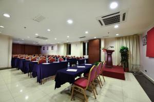 a conference room with tables and chairs and a podium at Bahagia Hotel Langkawi in Kuah