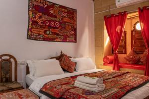 a bedroom with a bed with towels on it at Jaisalmer Murad Haveli in Jaisalmer +140 photos