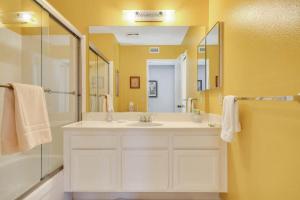 a bathroom with a sink and a shower with a mirror at Spectacular View Just Steps to Pool and Jacuzzi at Sunrise Country Club in Rancho Mirage +22 photos