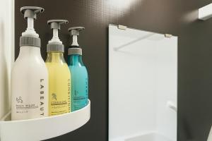 a rack with four bottles of wine in a bathroom at TOEI BUSSAN Building20 in Osaka +46 photos