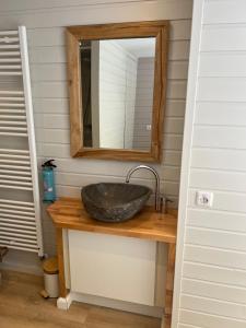 a bathroom with a stone sink and a mirror at Zandvoort Boutique Apartments in Zandvoort
