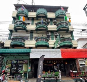 a building with flags on the front of it at The Clock Guesthouse in Udon Thani