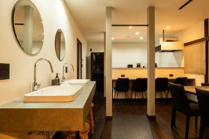 a bathroom with a sink and a dining room at J style villa Sapporo フルリフォーム 長期滞在にもオススメ マーケット近く in Sapporo +87 photos