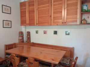 a dining room with a wooden table and cabinets at Rêverie Amatrice in Amatrice