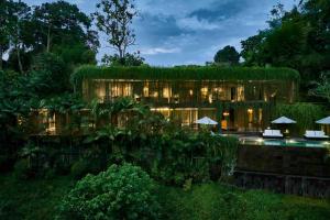 an exterior view of a building with a resort at Chameleon Villa Bali in Tabanan