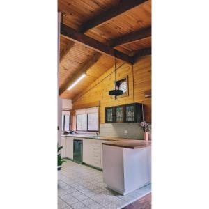 a kitchen with wooden ceilings and a counter top at Blue Wren Mews in Halls Gap +3 photos