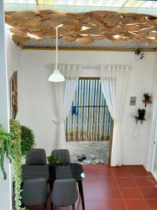 a living room with a table and chairs and a window at RoBin's Home in Da Thanh