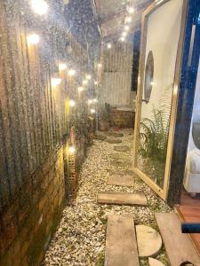 a long walkway with a mirror on a wall at RoBin's Home in Da Thanh