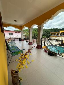 a view of a balcony with chairs and a pool at Apartamento Hotel Alfa y Omega in San Benito